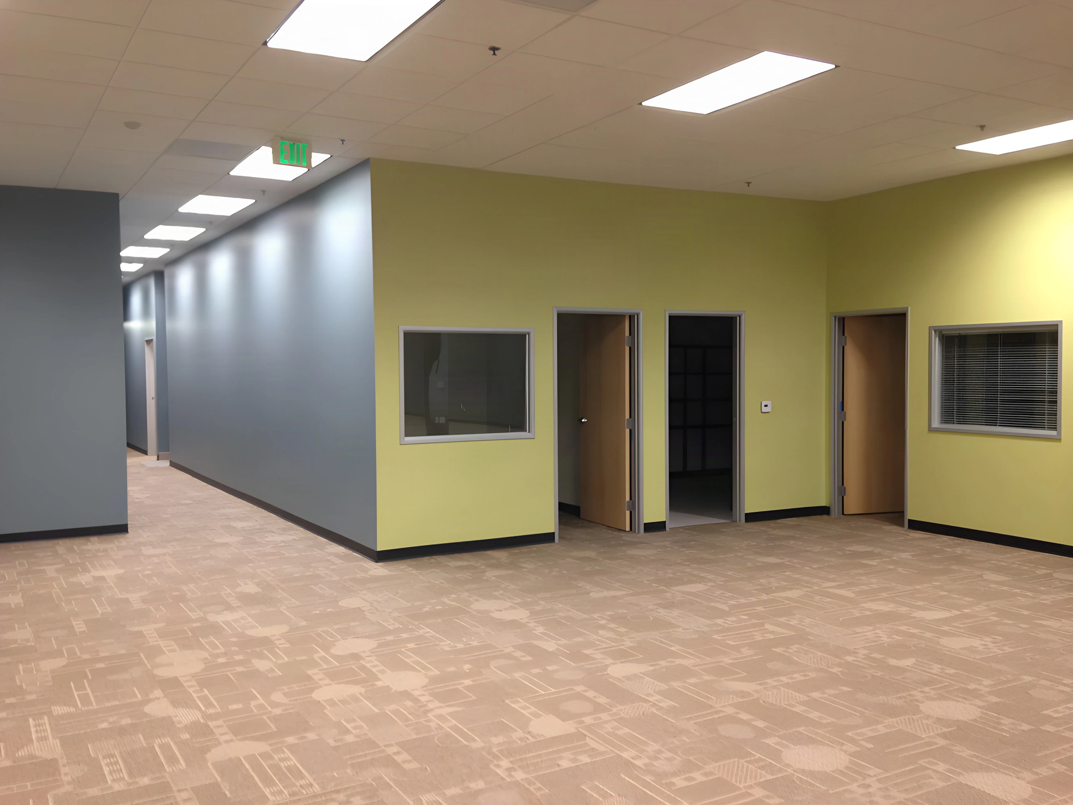 Row of offices with interior windows along a green wall in an Army career center