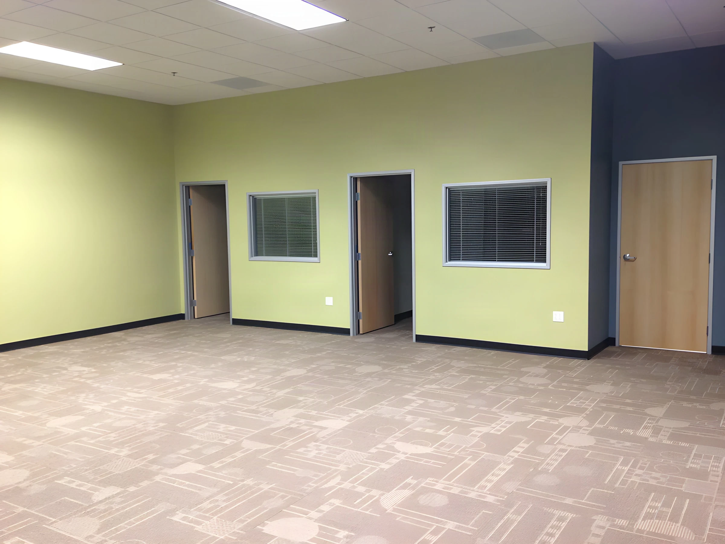 Green-walled private offices with wood doors and interior windows at an Army career center