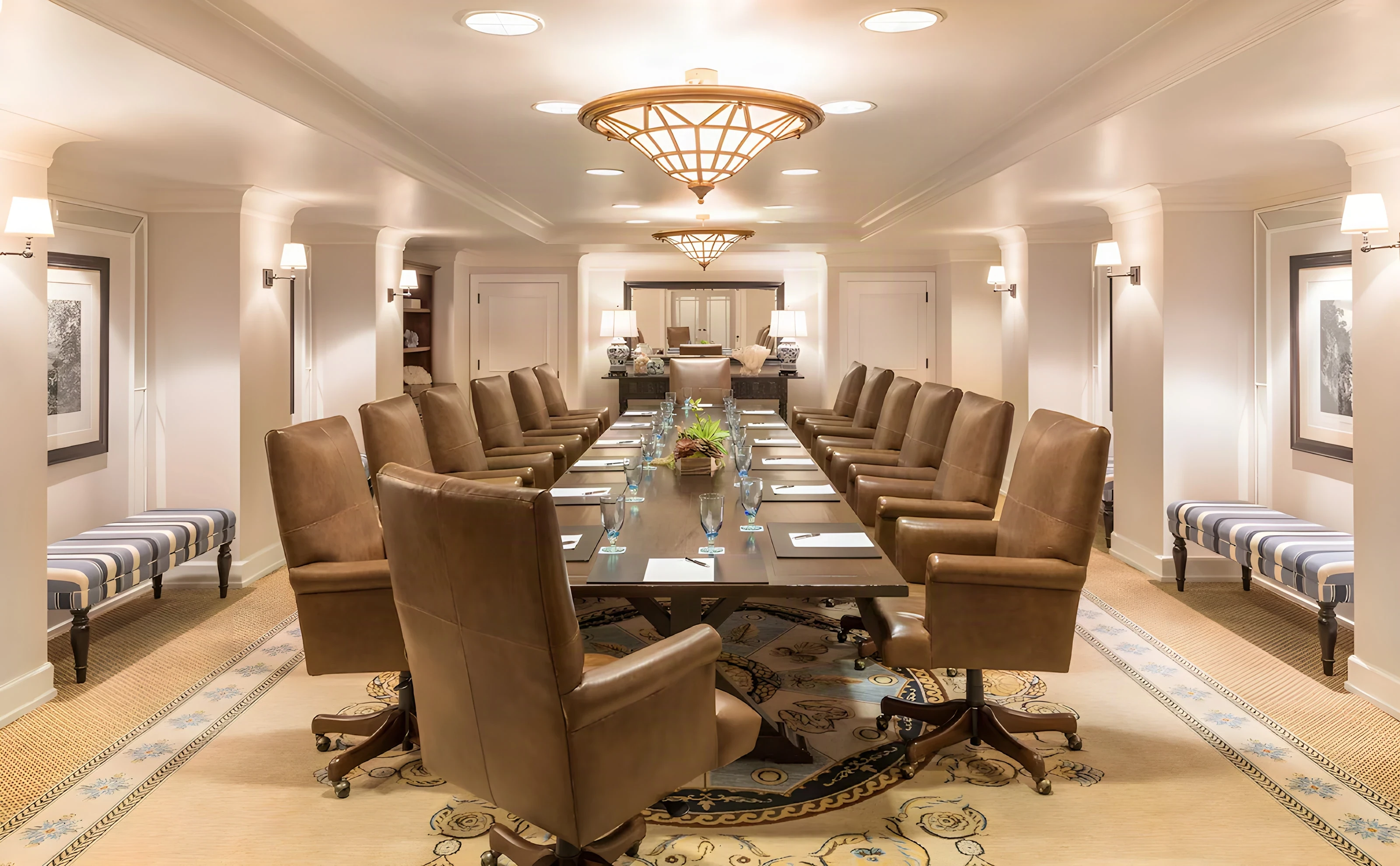Casa del Mar hotel boardroom with a long conference table, leather chairs and an ornate ceiling light