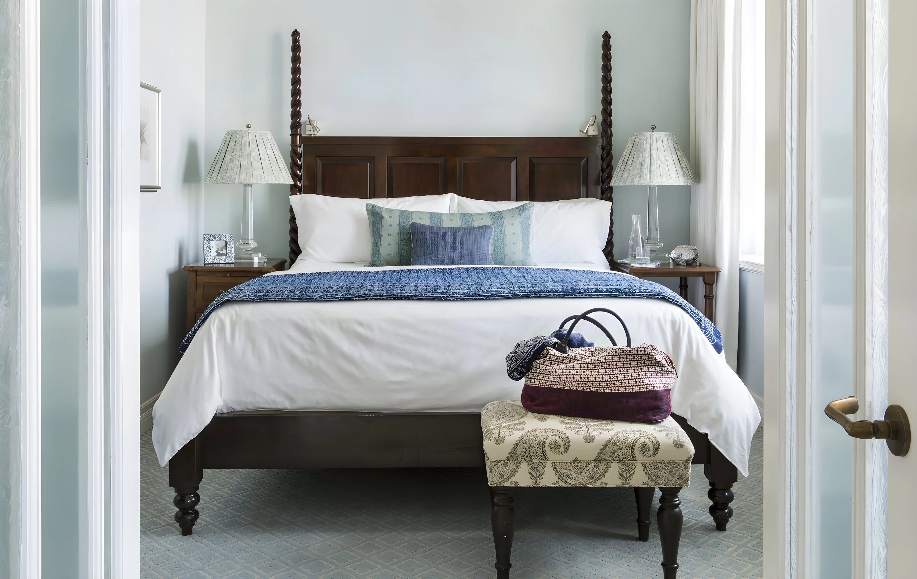 Four-poster bed in a refreshed Casa del Mar guest room with pale blue walls