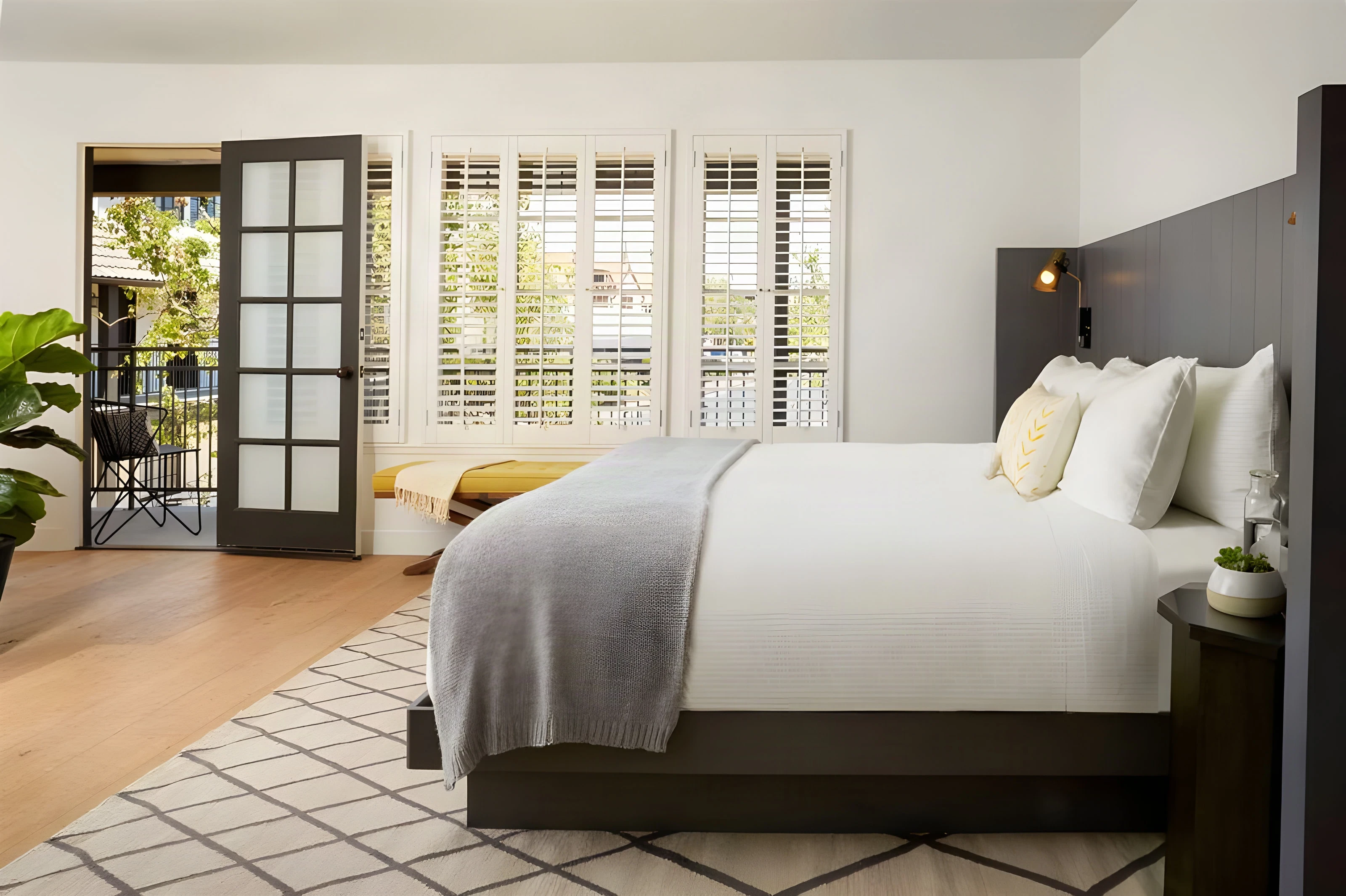 King room at The Landsby with a grey headboard and French doors to a balcony