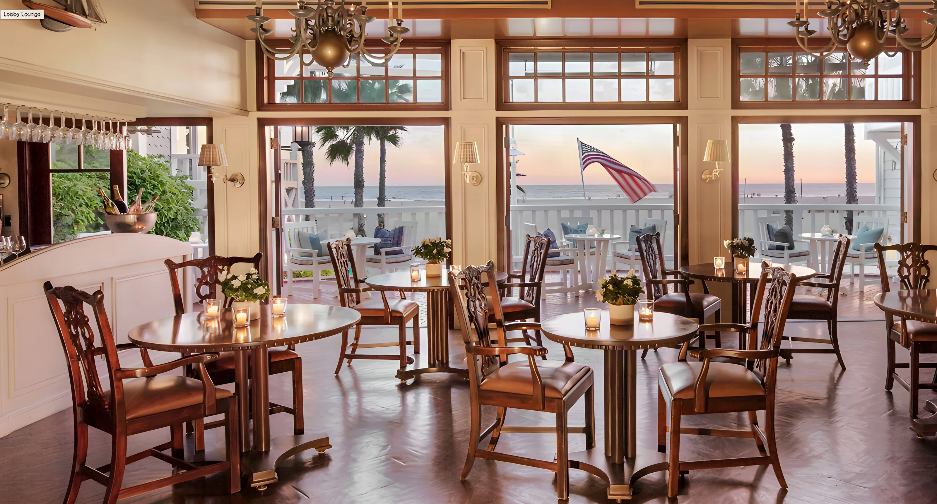 Dining room tables facing the beach through tall windows at Shutters on the Beach