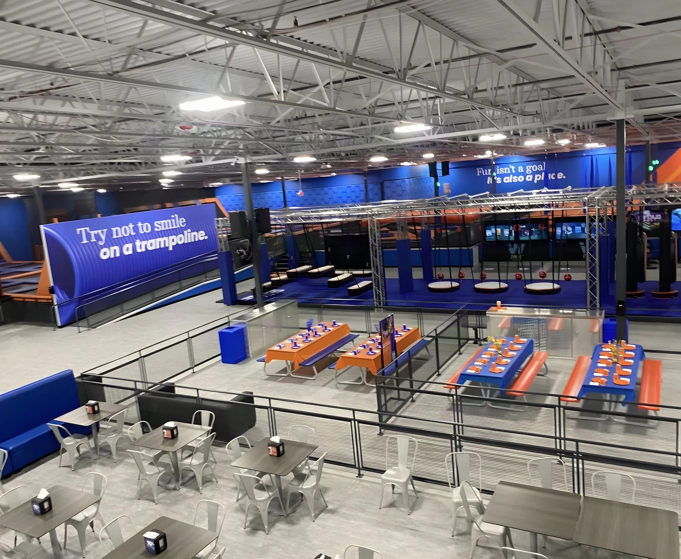Trampoline arena and party tables inside the Sky Zone park in Frisco, Texas